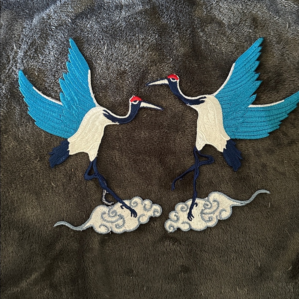 Embroidered Crane Design on Dark Fabric